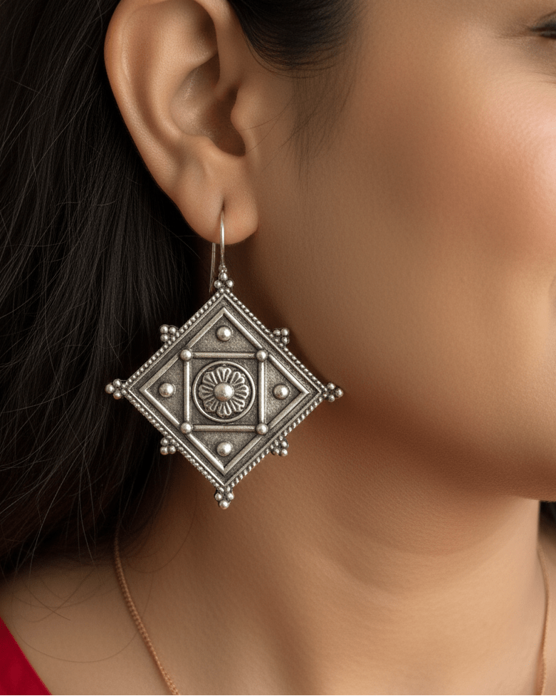Close-up of a person wearing an ornate art earring.