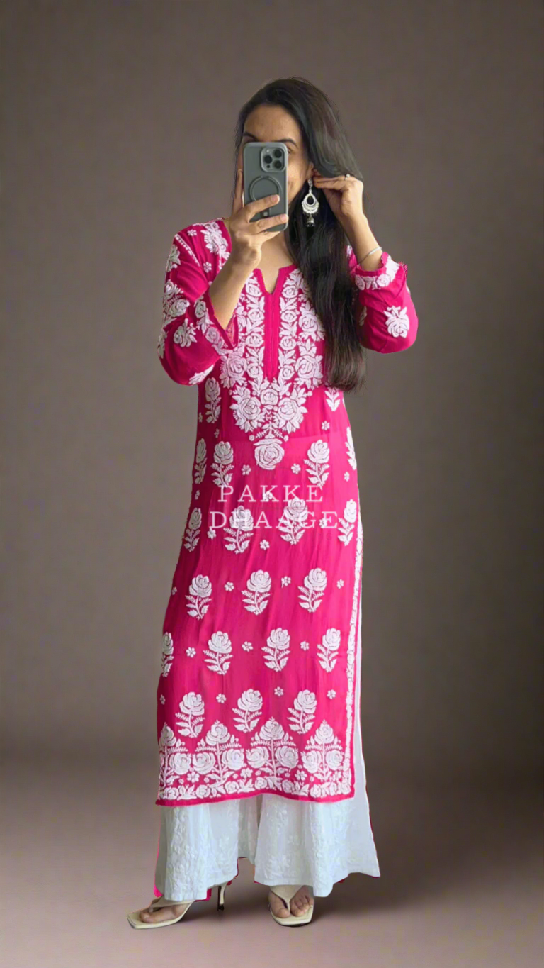 Person wearing a pink and white traditional chikankari kurti taking a mirror selfie.