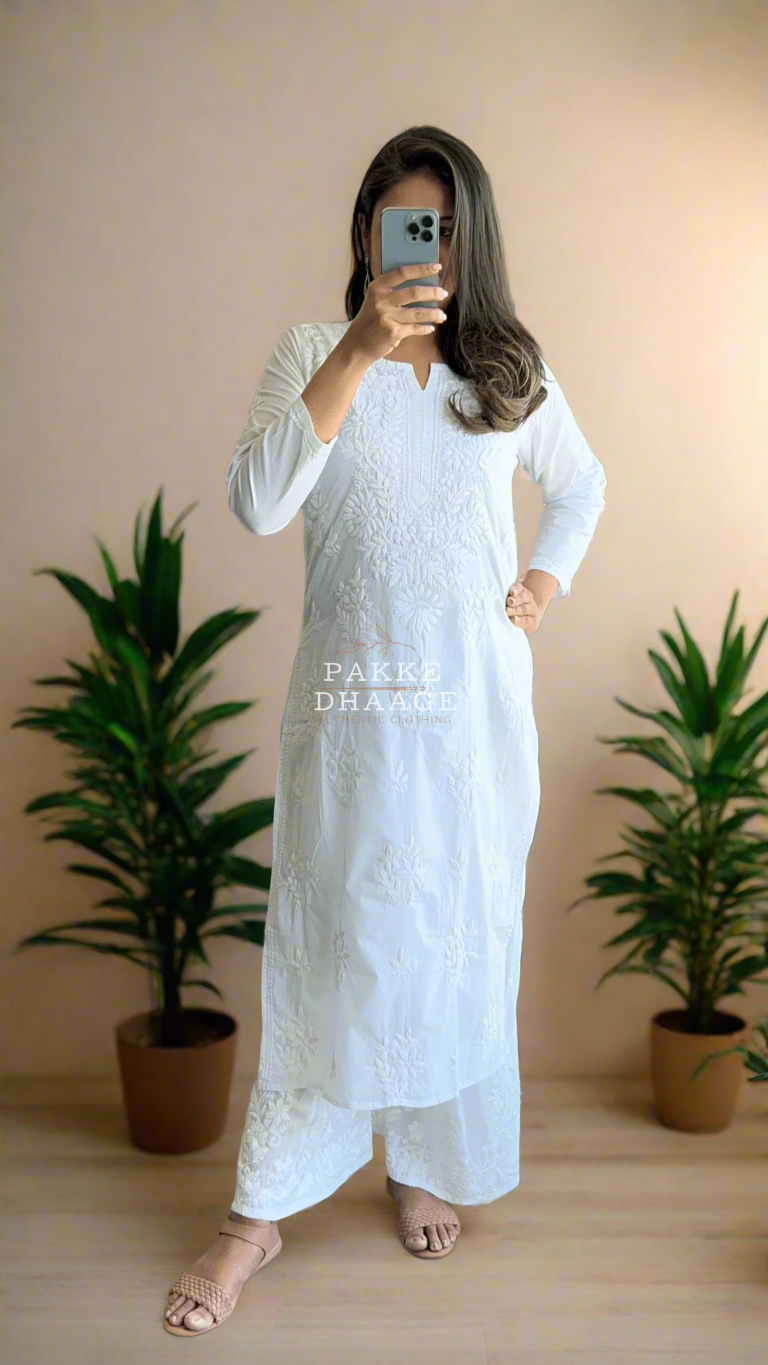 Person wearing a traditional white chikankari outfit
