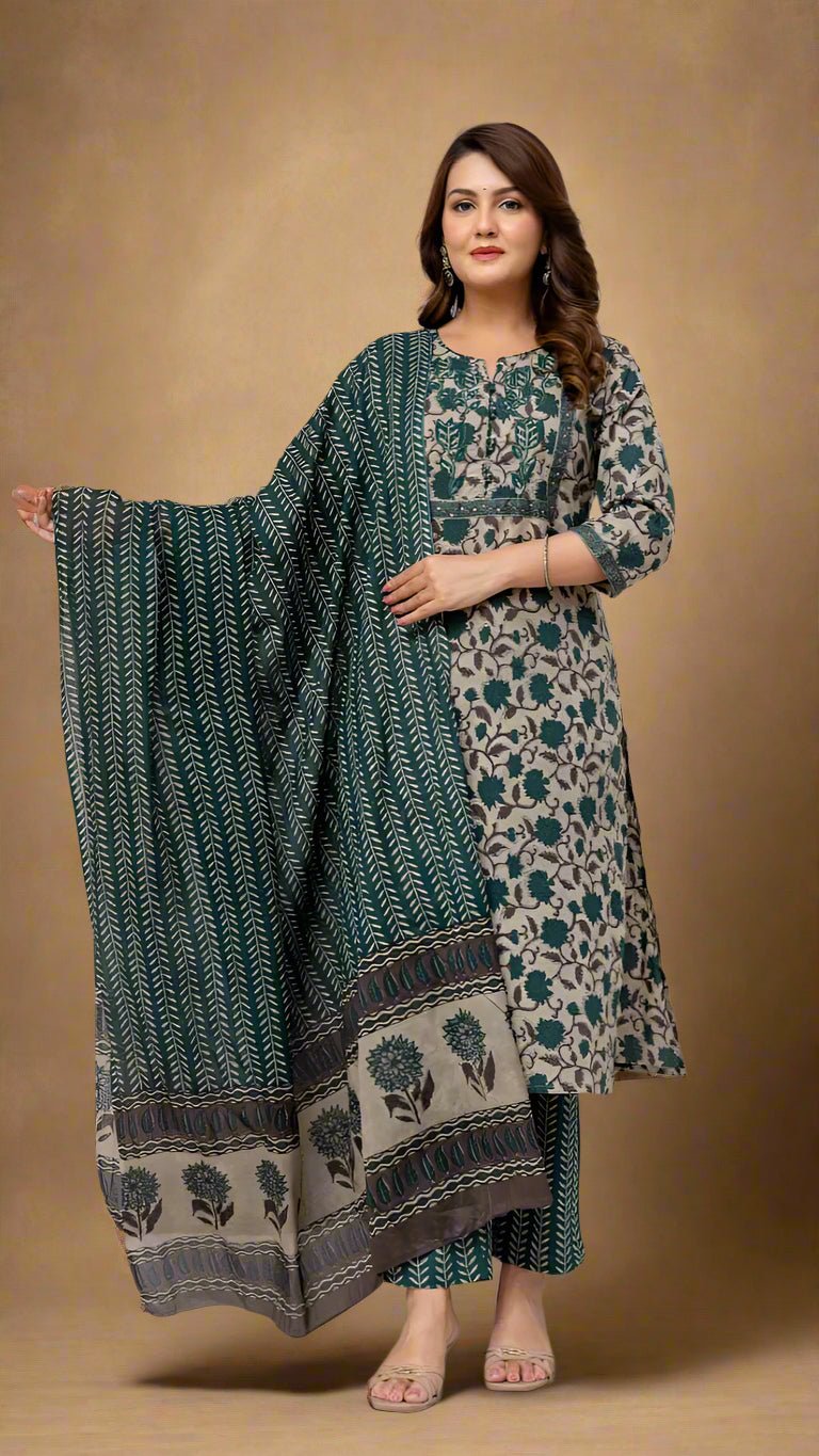 Woman wearing a green and beige traditional outfit with a matching dupatta against a textured background