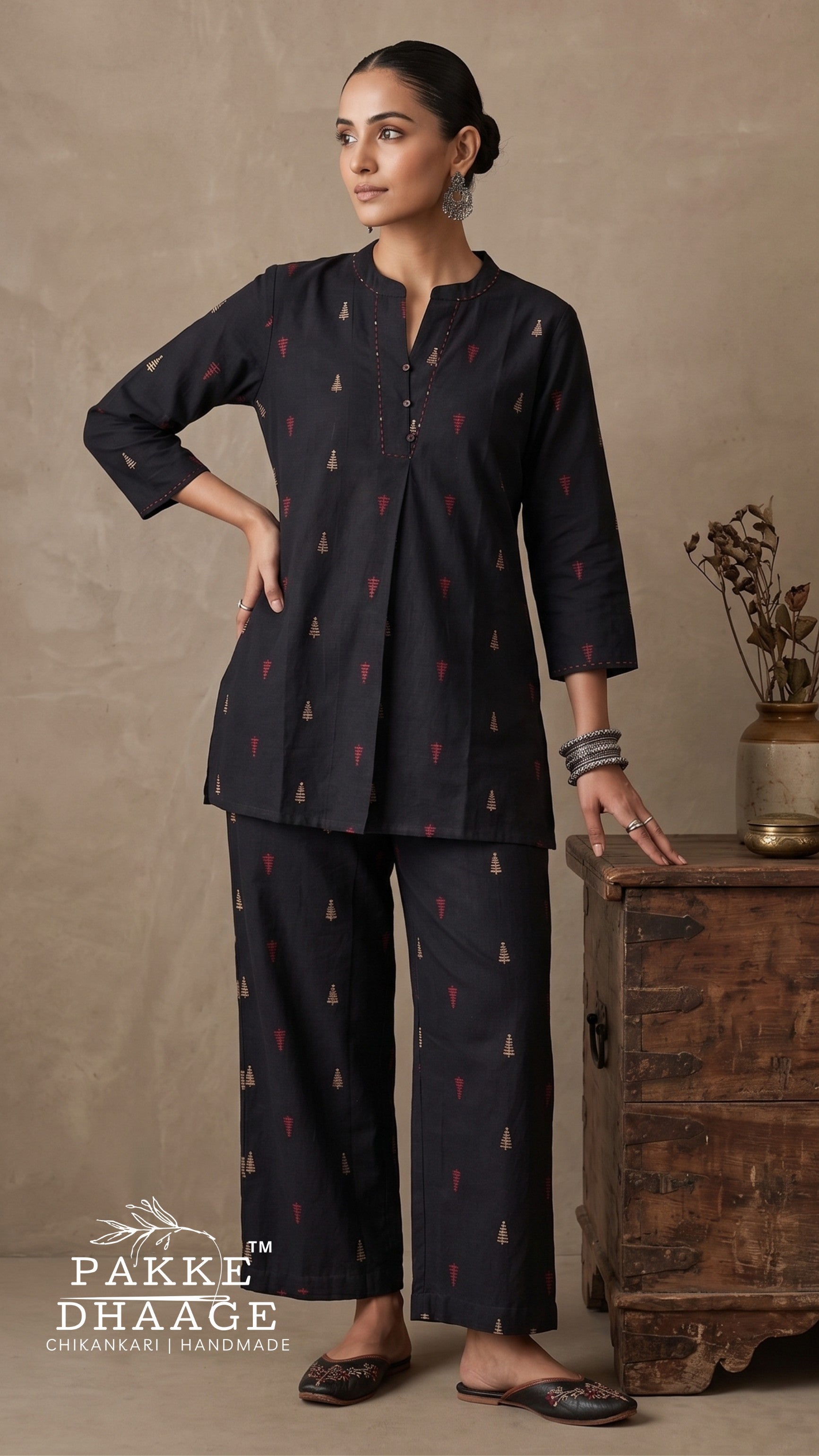 Model wearing a charcoal black pure cotton 2-piece printed co-ord set featuring a mandarin notch tunic with front inverted pleat and matching relaxed straight trousers.