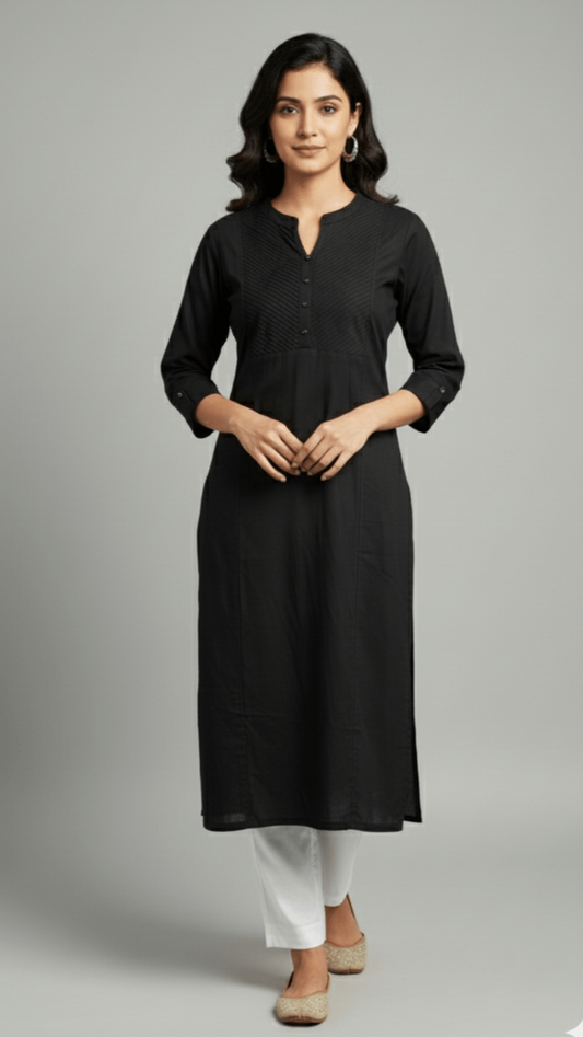 Woman wearing a black kurta with white pants on a gray background