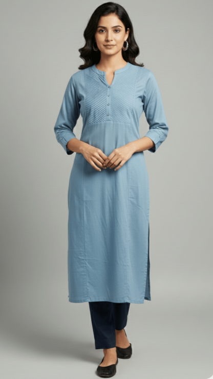 Woman wearing a light blue kurta with black pants on a gray background