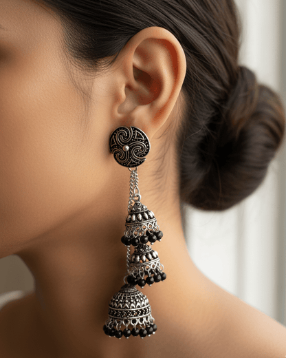 Cascade Oxidised Silver Earring worn by a person with a blurred background