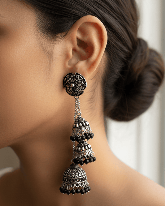 Cascade Oxidised Silver Earring worn by a person with a blurred background