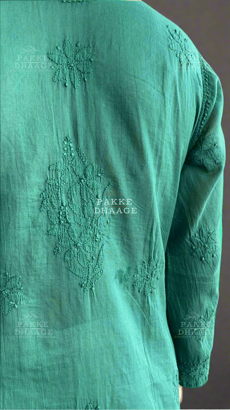 Green embroidered kurta with 'Pakke Dhaage' branding on a blurred background