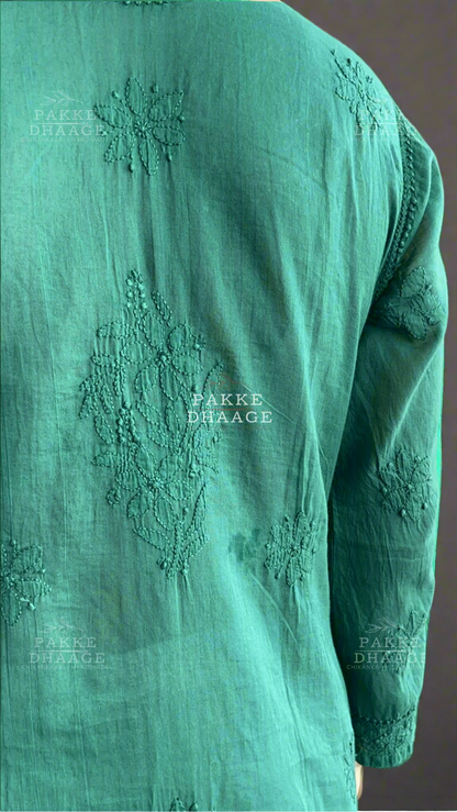 Green embroidered kurta with 'Pakke Dhaage' branding on a blurred background