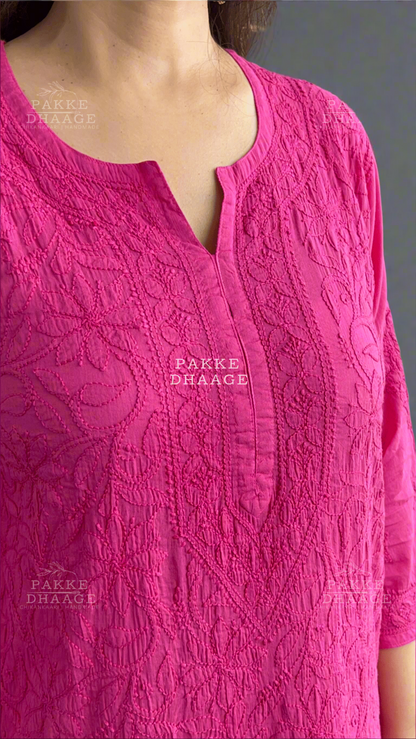 Close-up of a pink embroidered garment with 'Pakke Dhaage' branding.