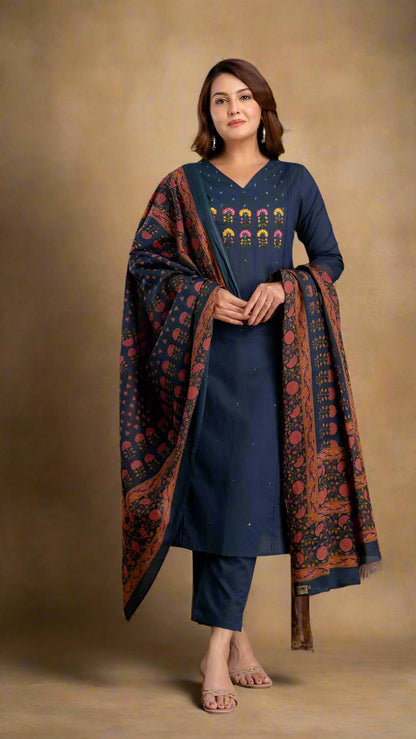 Woman wearing a blue kurta with a patterned dupatta against a beige background