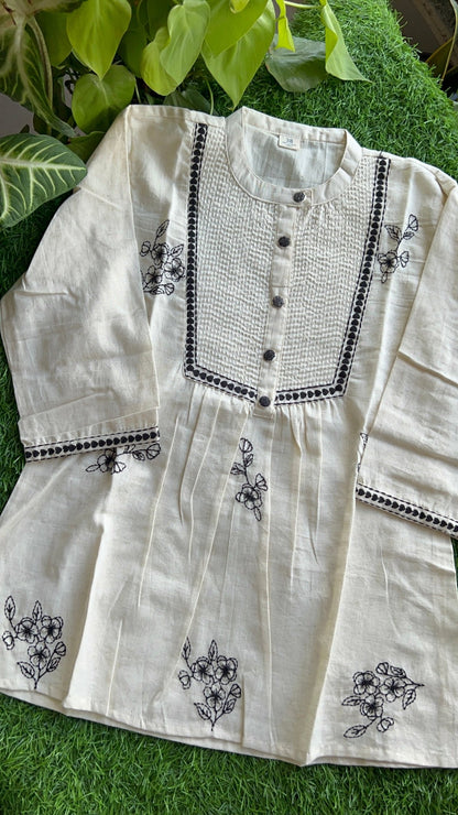 White embroidered top on a grass background, by Pakke Dhaage