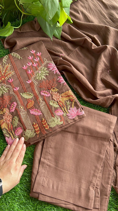 Brown embroidered suit set with floral patterns on a grassy surface