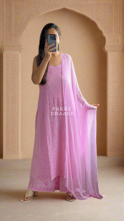 Person wearing a pink chikankari kurti set dress with a sheer dupatta in front of a mirror.