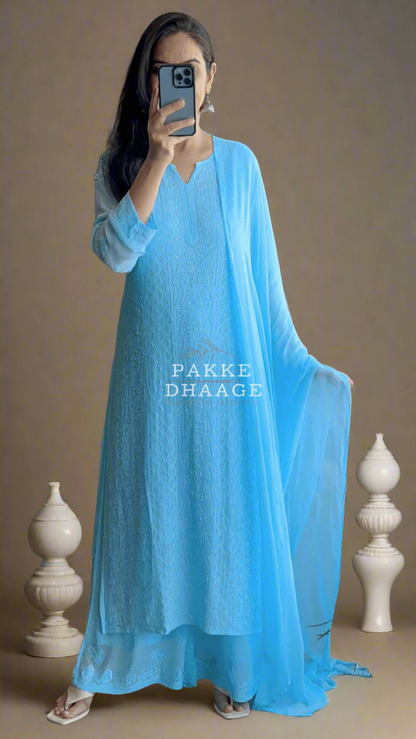 Person wearing a bright light blue chikankari suit set 