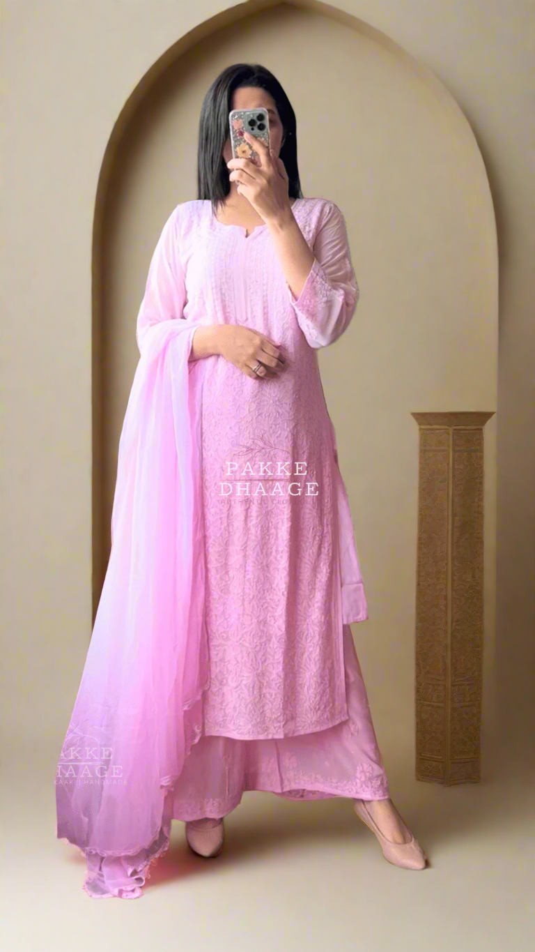 Person wearing a baby pink chikankari outfit taking a mirror selfie.