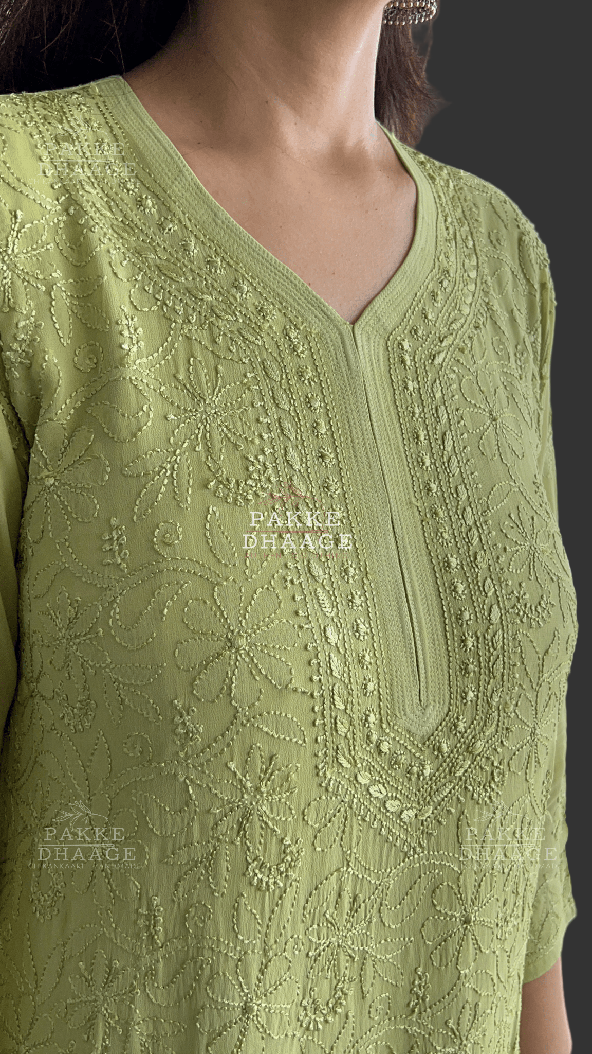 Close up shot of intricately embroidered chikankarui kurti in green color