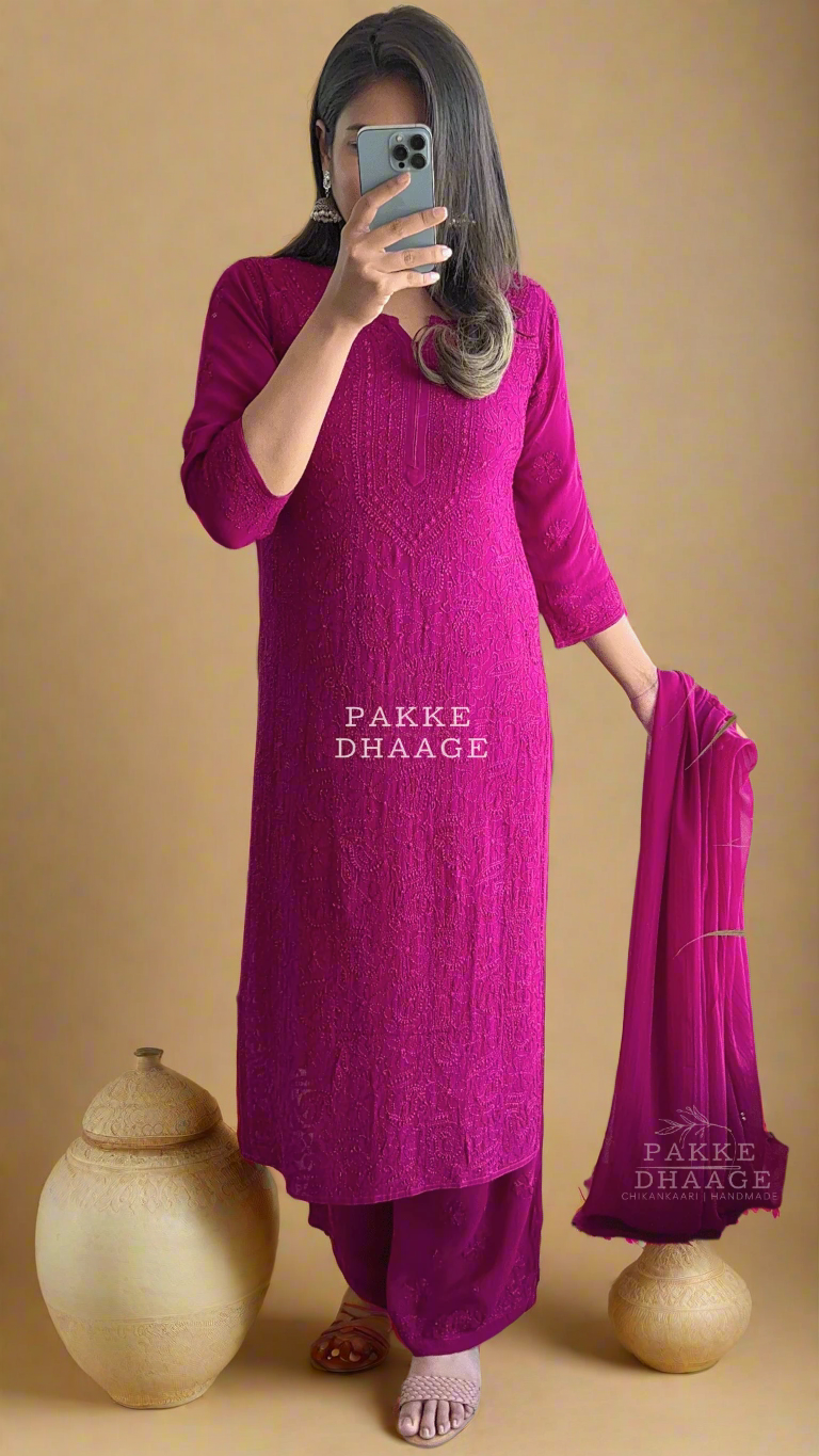 Person wearing a bright pink traditional chikankari handmade outfit with 'PAKKE DHAAGE' branding.