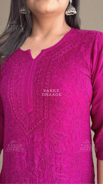Close-up of a person wearing a pink embroidered chikankari kurta with 'Pakke Dhaage' branding.