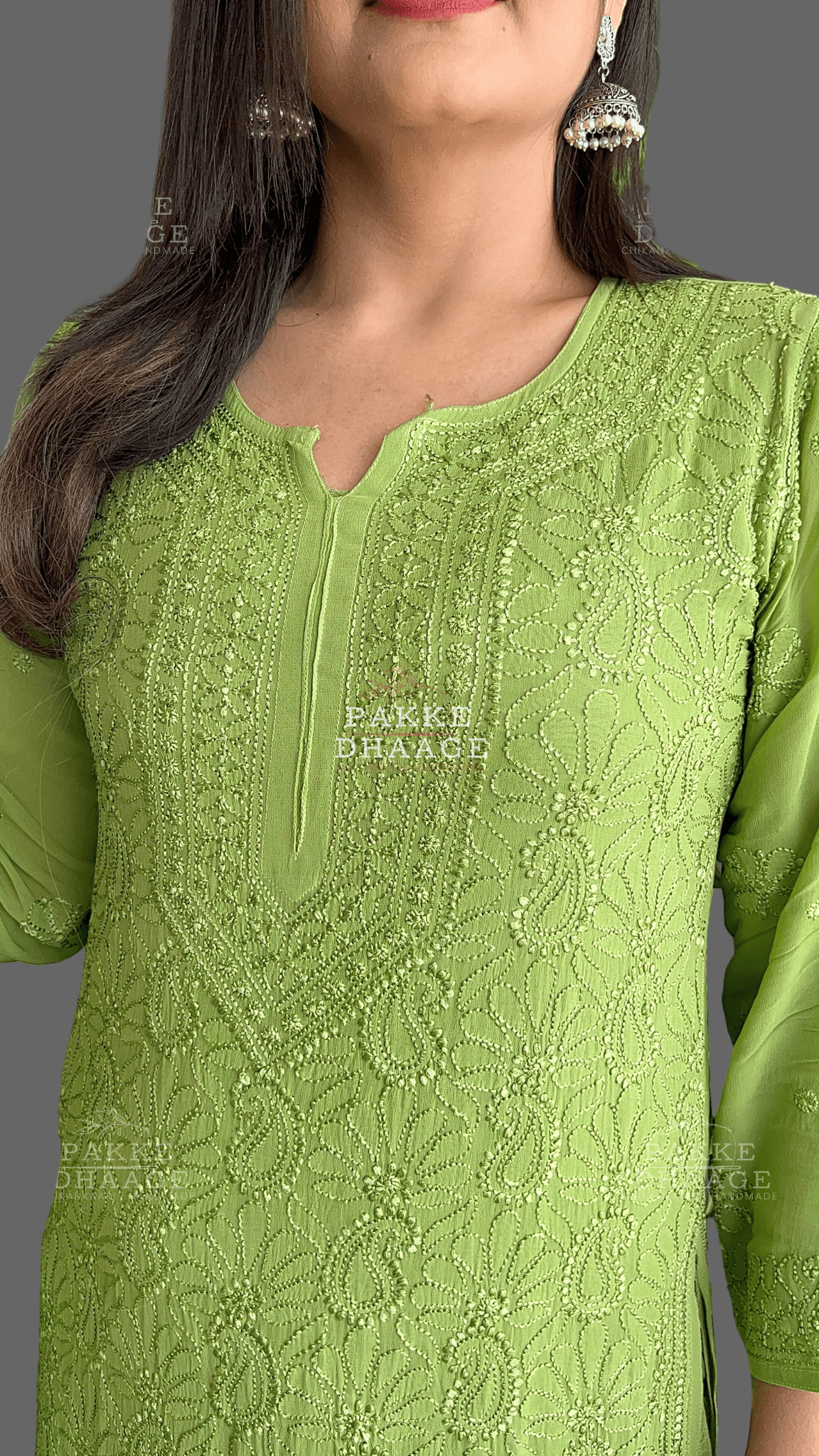 close-up shot of a woman wearing a green chikankari outfit, showing intricate details and motifs