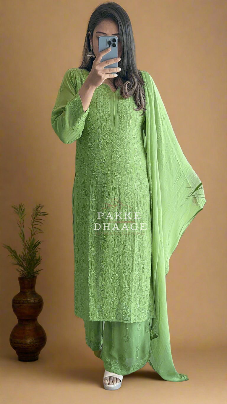 Person wearing a green chikankari suit with a matching sheer dupatta.