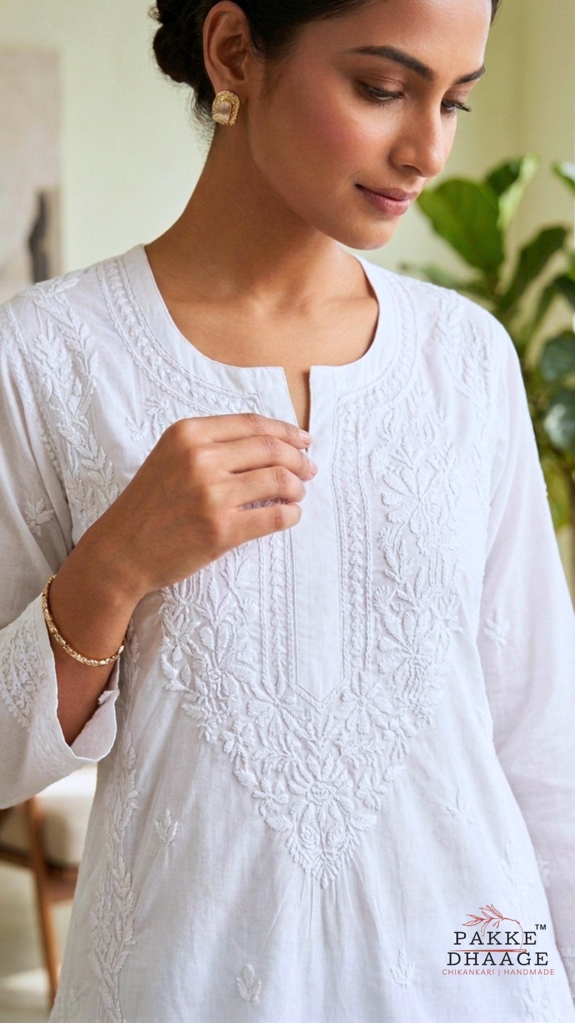 Woman wearing a white hand embroidered chikankari kurta with 'Pakke Dhaage' branding.