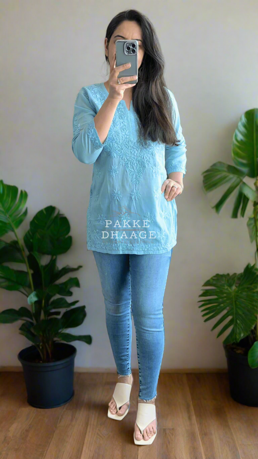 Woman wearing a powder blue chikankari short top 