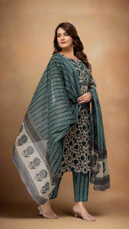 Woman wearing a green and patterned outfit with a matching shawl against a white background