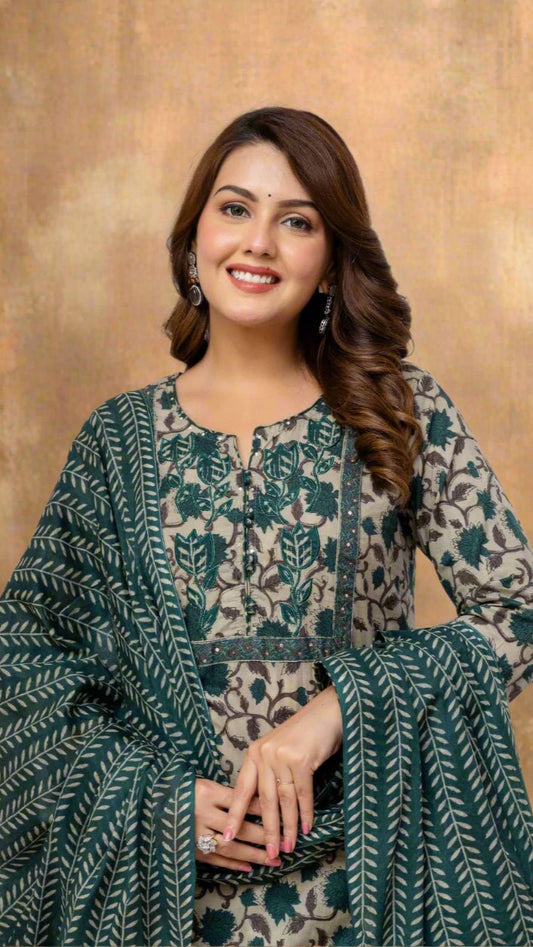 Woman wearing a green and beige patterned outfit against a white background