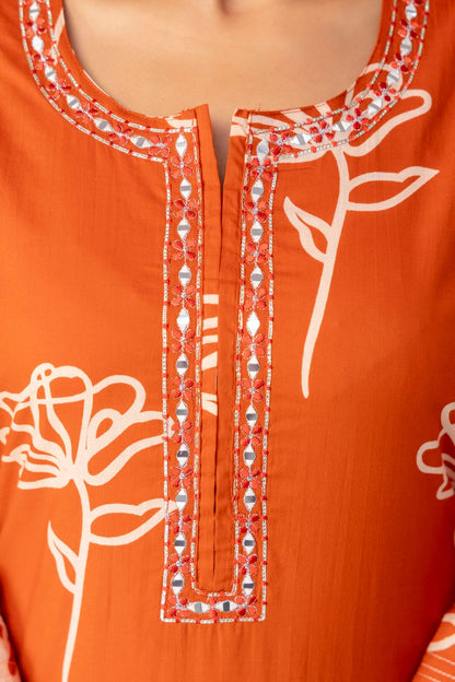 Orange garment with white floral embroidery and decorative patterns