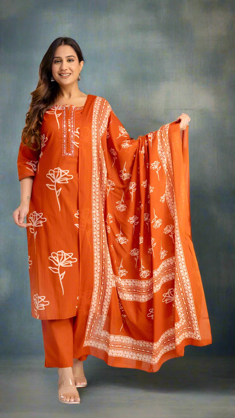 Woman wearing an orange traditional outfit with white patterns on a plain background