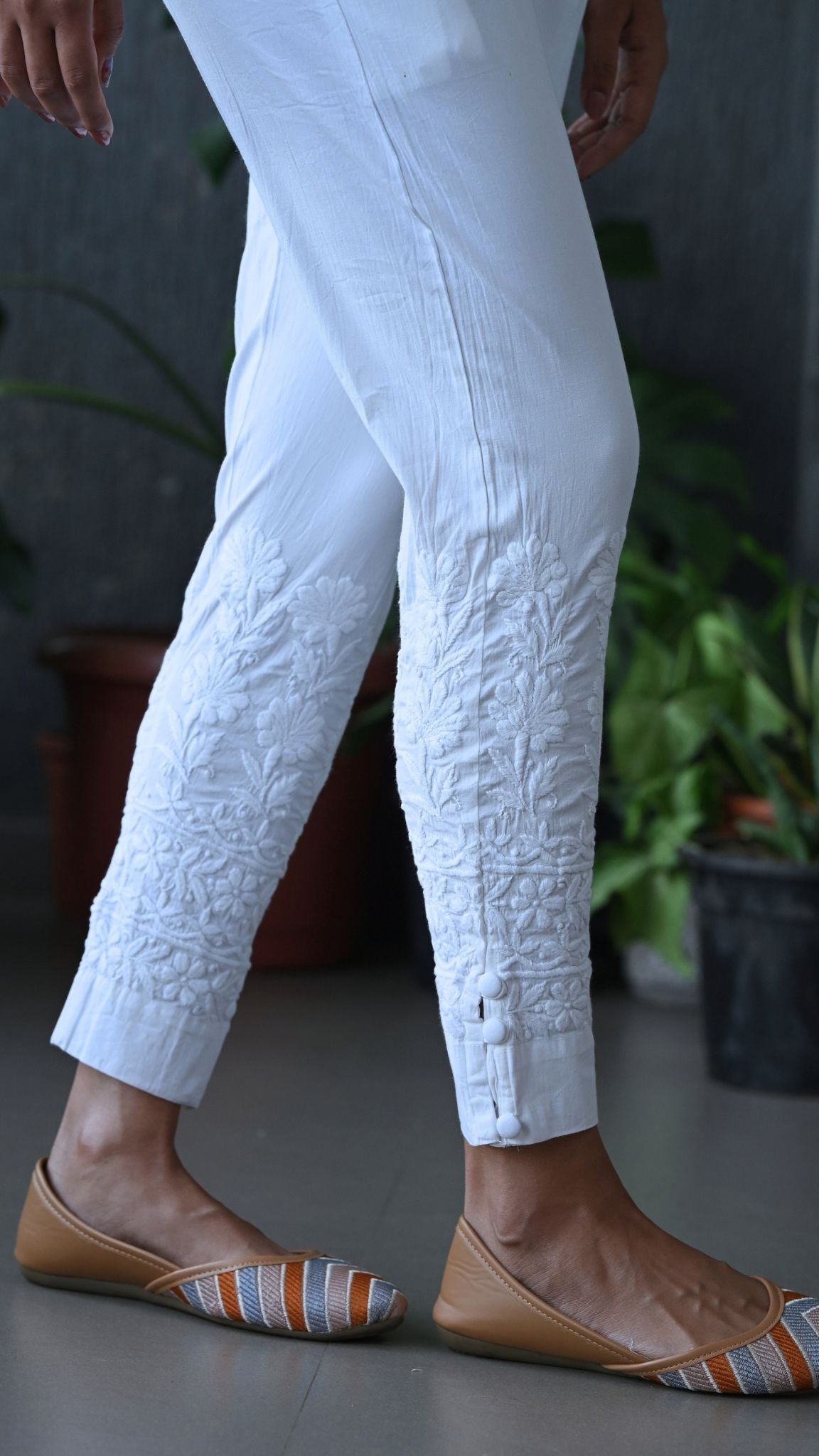 White cotton trousers with intricate floral chikankari along the lower hems. | Pakke Dhaage